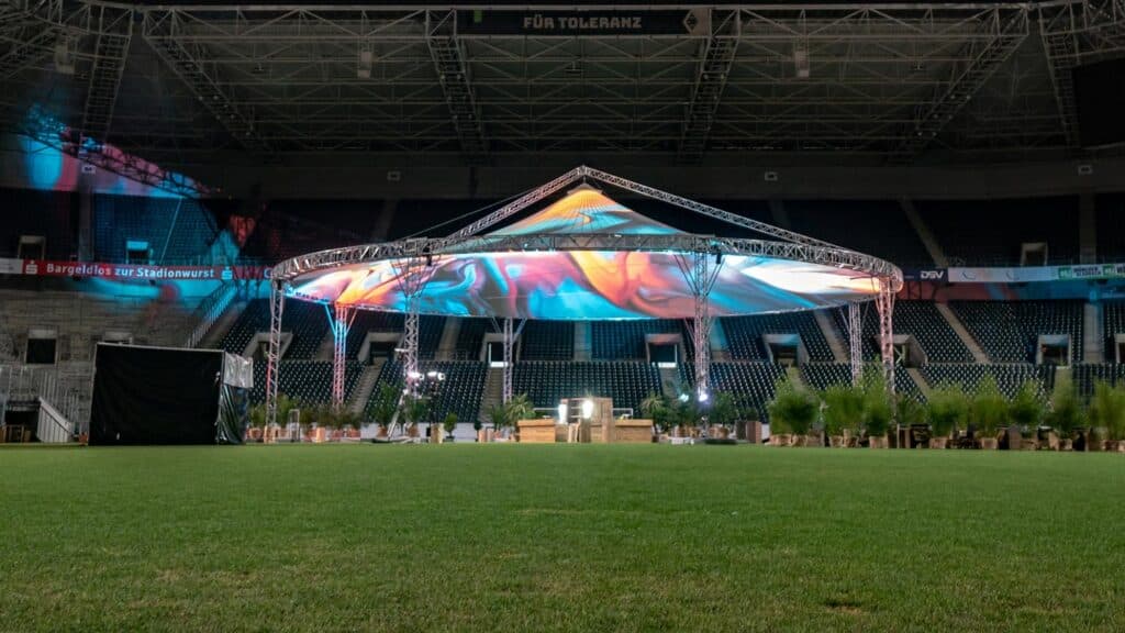 Colorful event tent setup at a stadium for outdoor entertainment.