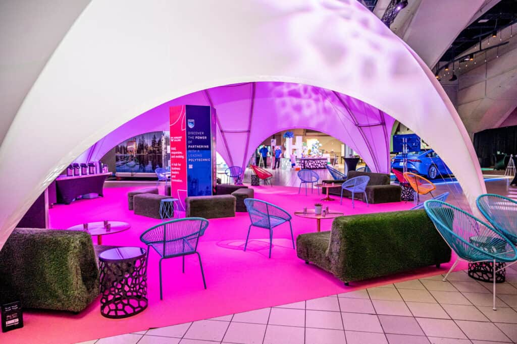 Other Rentals 2 Elegant event tent interior with vibrant purple lighting, modern furniture, and spacious seating areas for corporate or private gatherings.