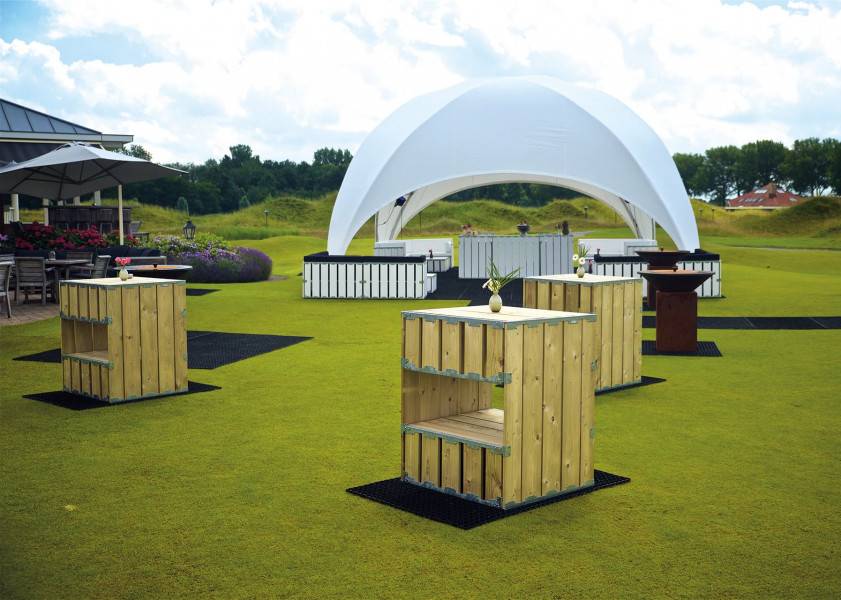 Elegant tent setup with outdoor furniture and overhead canopy for events.
