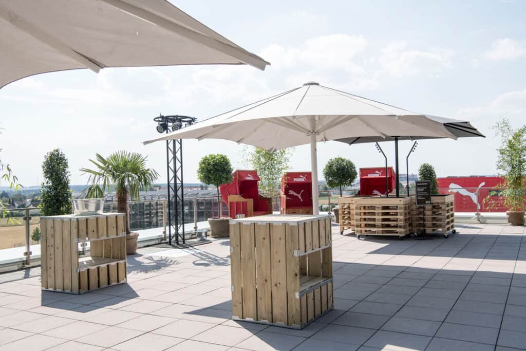 Bright rooftop event space with upscale tent rentals and stylish decor, perfect for outdoor gatherings and celebrations.