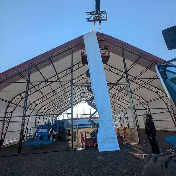 Industrial tent construction in progress at Superior Tent Rentals, showcasing large event tent setup, temporary shelter, and professional tent installation for events and outdoor functions.