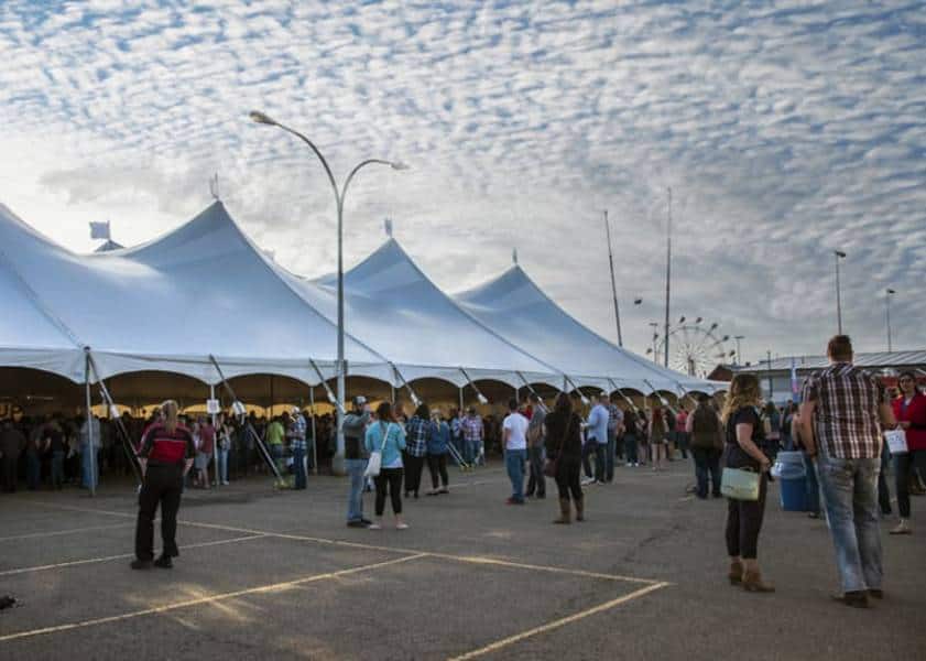 Large event tent rental at outdoor festival for weddings and parties.